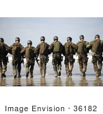 #36182 Stock Photo Of A Line Of Soldiers Walking Away Towards The Surf On A Beach
