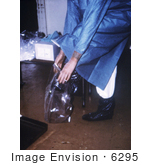 #6295 Picture of a Doctor Putting On Plastic Boot Covers by KAPD