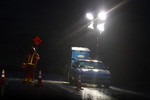 Free Picture of Road Construction Flagger at Night in the Rain