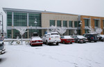 Free Picture of Cars Parked on a Snow Covered Parking Lot Infront of the Jackson County Library