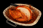 Free Picture of Thanksgiving Cut Turkey with a Knife in a Pan