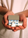 Free Picture of Man Holding a Model House in His Hands