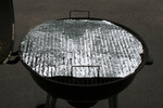Free Picture of Foil With Holes Covering a Rusty BBQ Grill