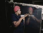 Free Picture of African American Woman Drilling on Side of Bomber