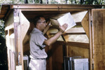 Free Picture of Cdc Field Researcher Moving a Mosquito Cage from a Horse Stable Mosquito Trap