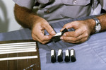 Free Picture of Field Researcher Labeling Glass Tubes Filled with Mosquitoes that will be used in an Arbovirus Study - 1980