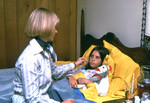 Free Picture of Mother Caring for Her Child who is in Bed Sick with a Cold - 1976