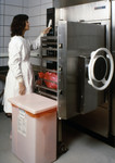 Free Picture of Female Scientist Working with an Early Model Autoclave System