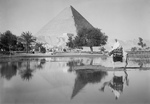 Free Picture of Man on Camel Near Pool of Water, Pyramids in the Background