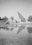 Free Picture of Man on Camel Near Pool of Water, Pyramids in the Background