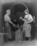 Free Picture of Blacksmiths Making a Wagon Wheel