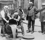 Free Picture of Men Pouring Liquor Into a Sewer During Prohibition