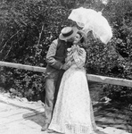 Free Picture of Man and Woman Kissing Under a Parasol