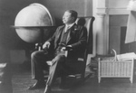Free Picture of Theodore Roosevelt Sitting by Globe