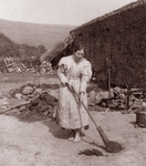 Free Picture of Woman Sweeping By a Spinning Wheel