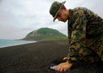 Free Picture of Soldier Collecting Sand From Iwo Jima