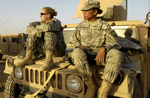 Free Picture of Two Female Army Soldiers on a Vehicle