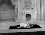 Free Picture of Girl Sleeping on a Rug Near a Fireplace