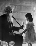 Free Picture of Little Girl Lighting an Old Man’s Pipe