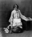 Free Picture of Helen Keller Reading Braille and Petting a Dog