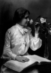 Free Picture of Helen Keller Smelling a Rose and Reading Braille
