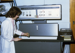 Free Picture of Laboratorian Using an Older Model Liquid Scintillation Counter in a Laboratory