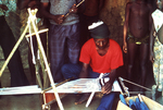 Free Picture of Villagers Watching a Motehun, Sierra Leone Weaver Practicing His Craft