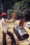 Free Picture of Person Standing Beside a Rice Processing Machine at a 1976 Sierra Leone Lassa Fever Field Study