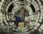 Three women working inside circular structure of the fuselage
