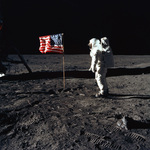 Stock Picture of Astronaut Buzz Aldrin by an American Flag on the Moon